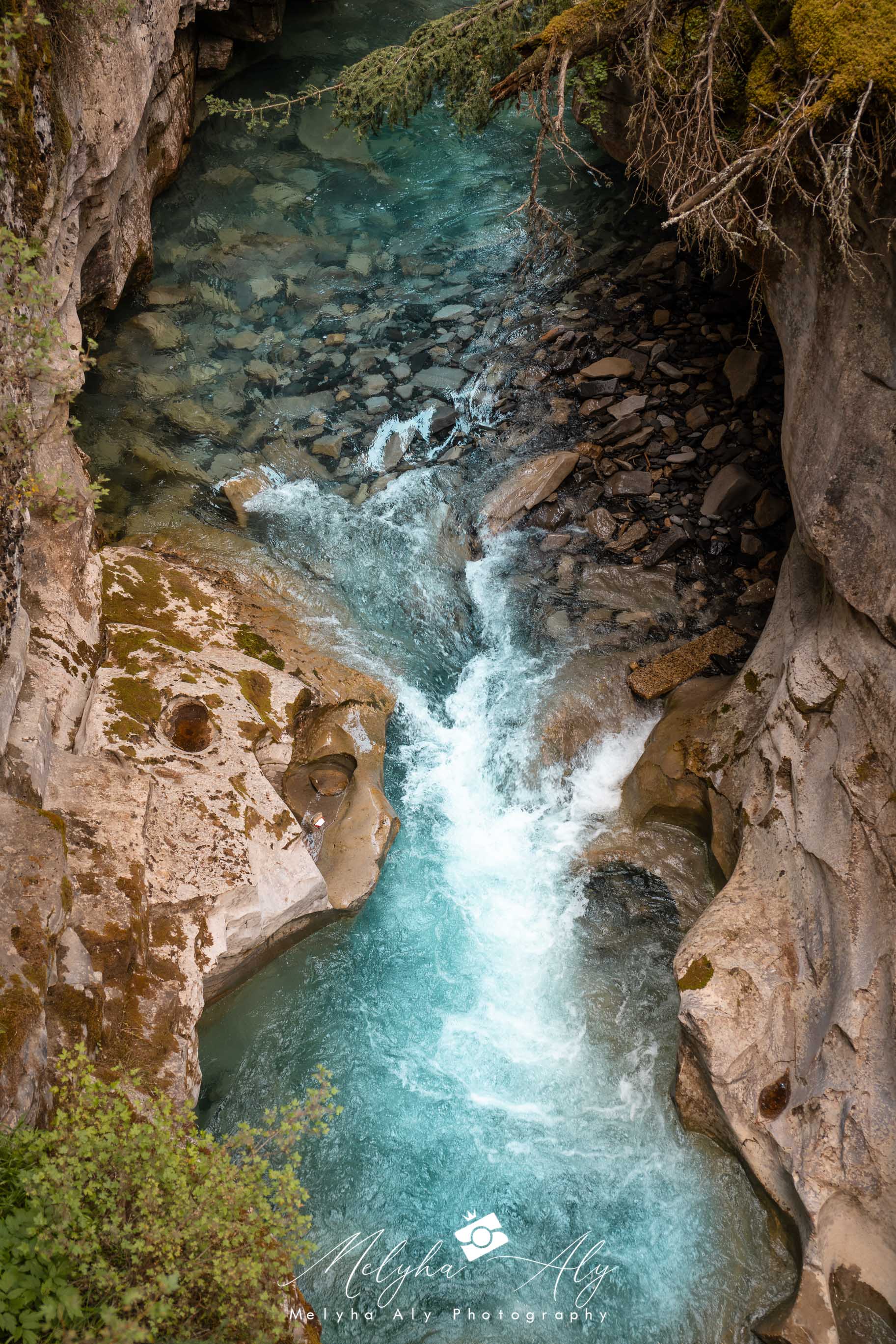 Scenic view of Johnston Canyon's dramatic rock formations and flowing water